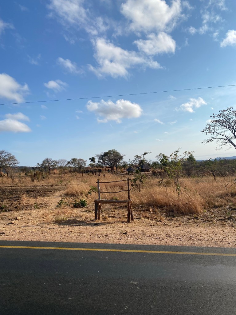 Wooden bench visible on the road to Lusaka 