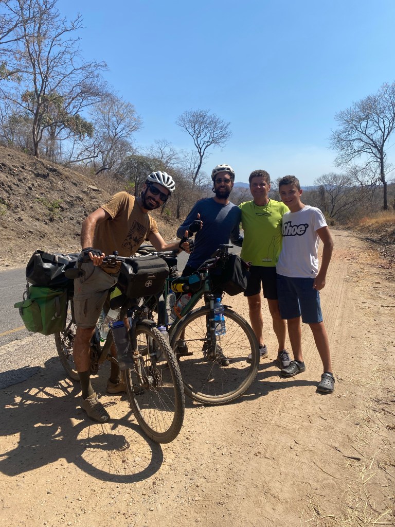 Gaspard and javi meeting Italian family while cycling in Zambia next to south luangwa