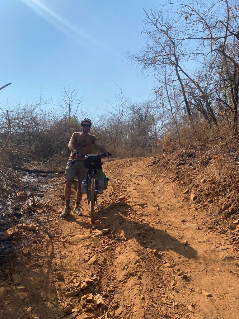 Javi walking downhill on the road to chirundu 
