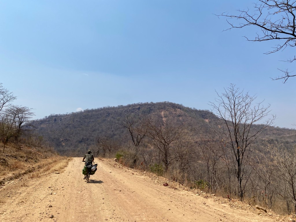 Javi on the bicycle in Zimbabwe on an uphill