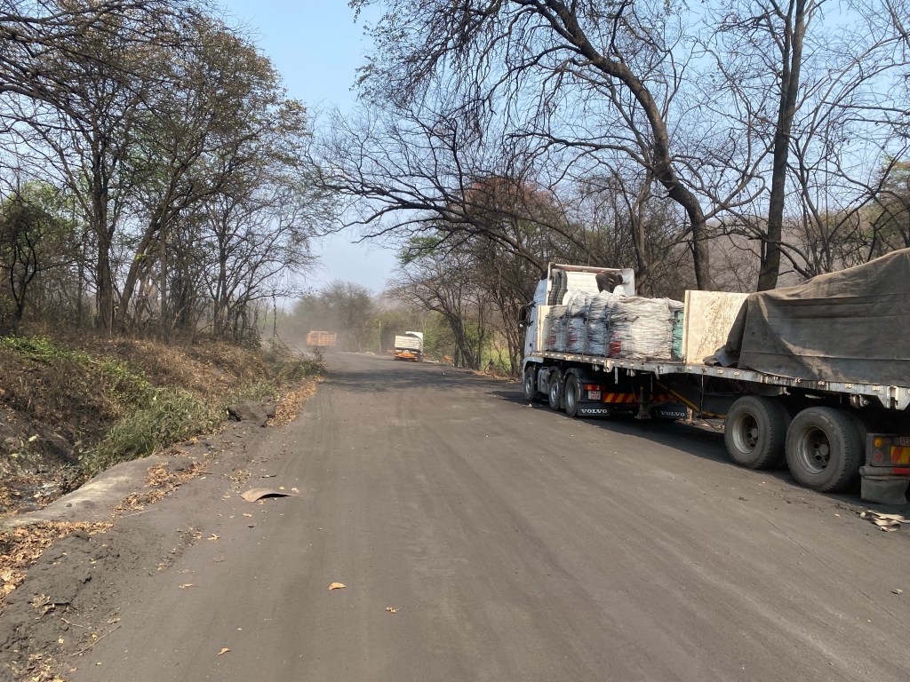 Arriving close to a coal mine in Zimbabwe on a black road