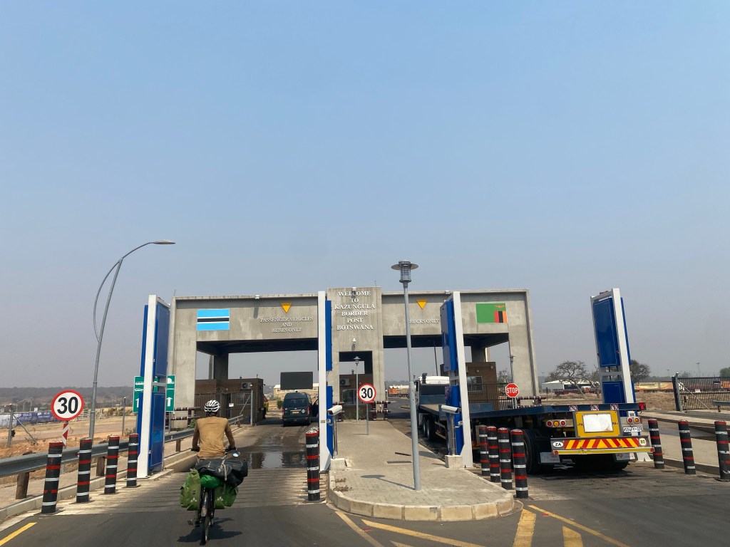 Border post with a cyclist between Zambia and Botswana 