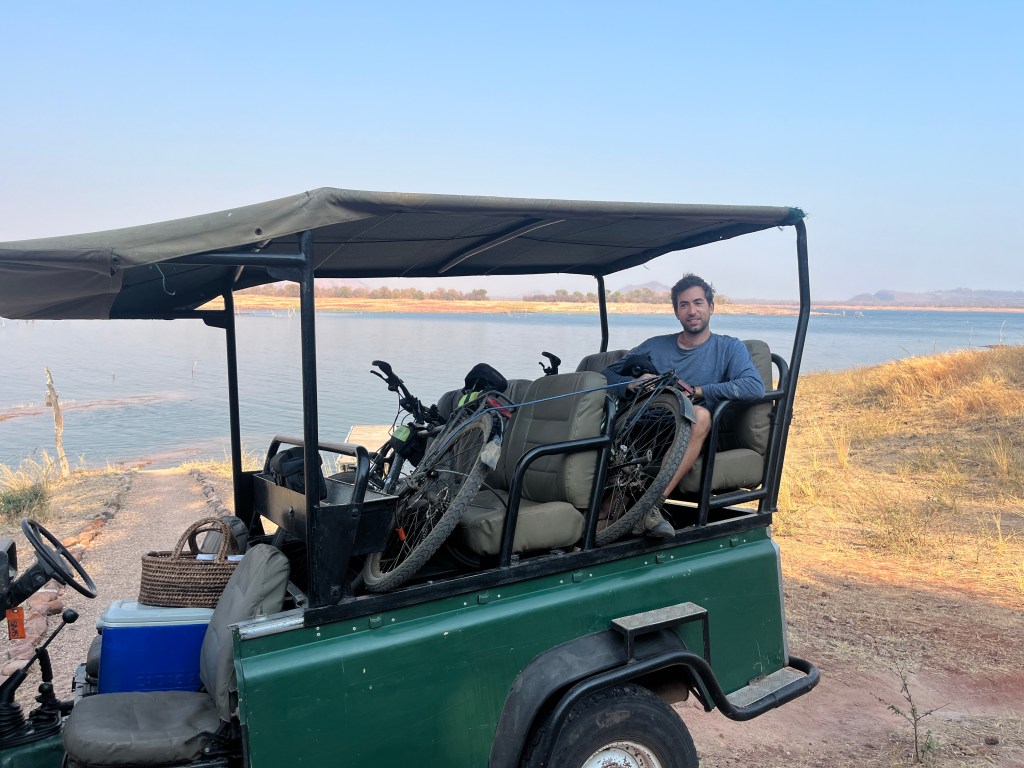 Gaspard and our bicycle in the Range Rover of musango park
