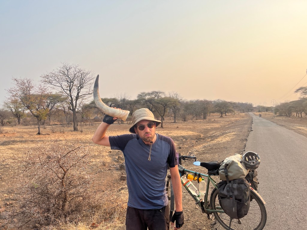 Cyclist with a cow’s horn in Zimbabwe