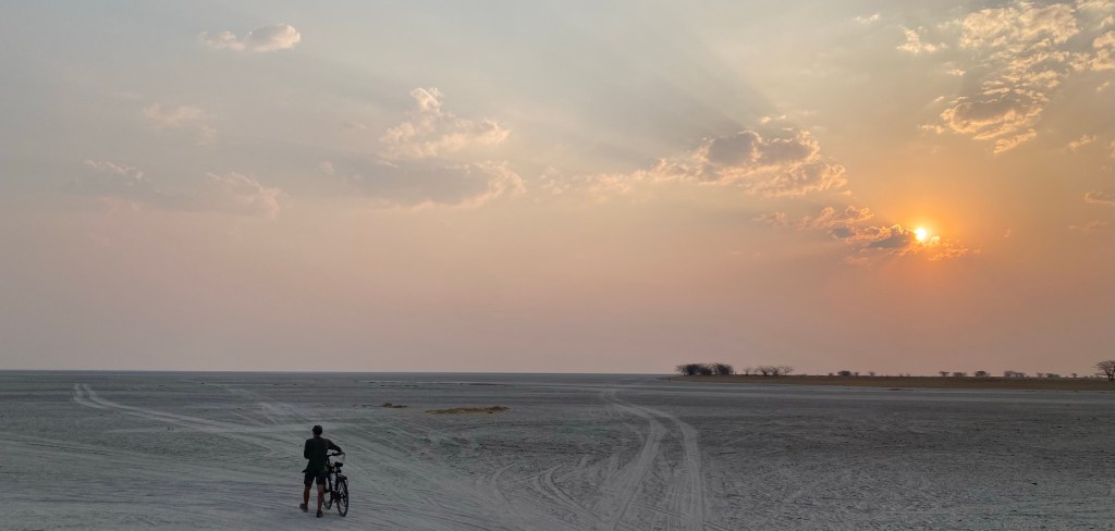 A cyclist entering Nata bird sanctuary at sunset