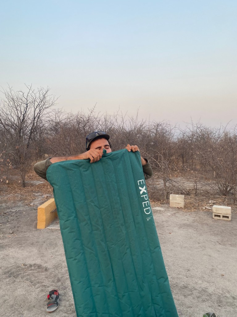 A cyclist inflating his air mattress 