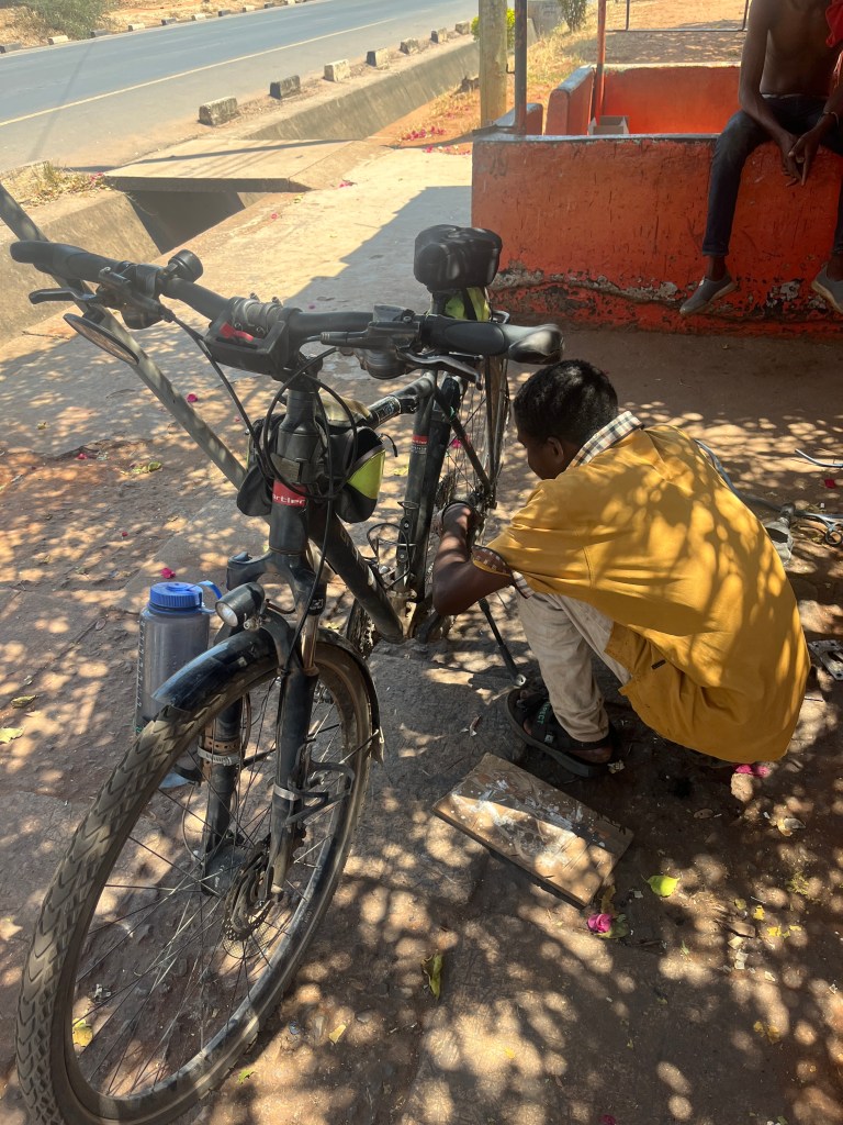 A worker in Zambia Livingstone trying to fix the kickstand of our bicycle 