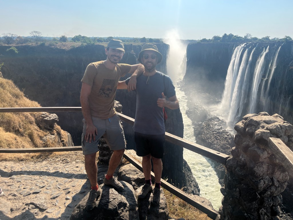 Two cyclist in front of Victoria falls from Zambia side 