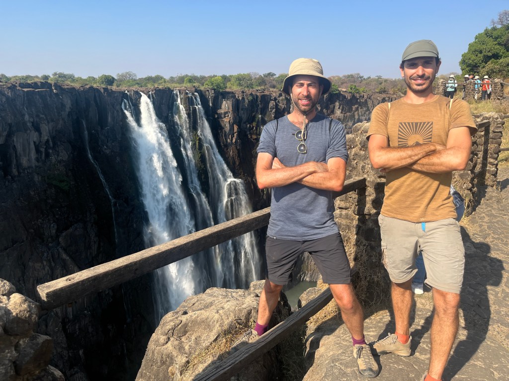 Two cyclist in front of the Victoria falls in Zambia 