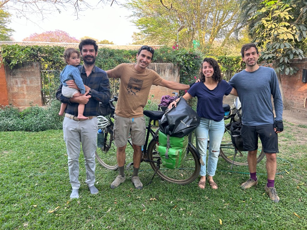 Two cyclist leaving the house of their hosts in lusaka