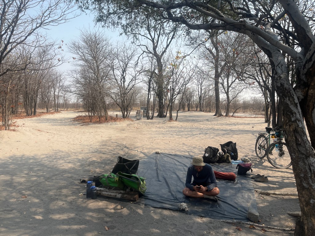 A cyclist having a break in Nata bird sanctuary 