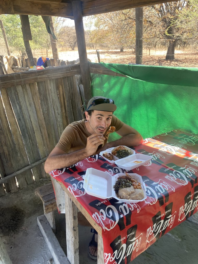 A cyclist eating local food in Maun Botswana 