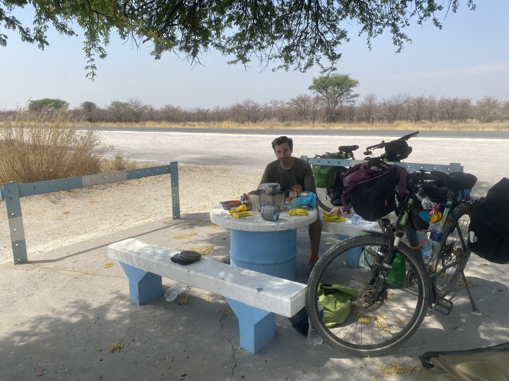 Bikepacker having a picnic with two bicycle in Namibia 
