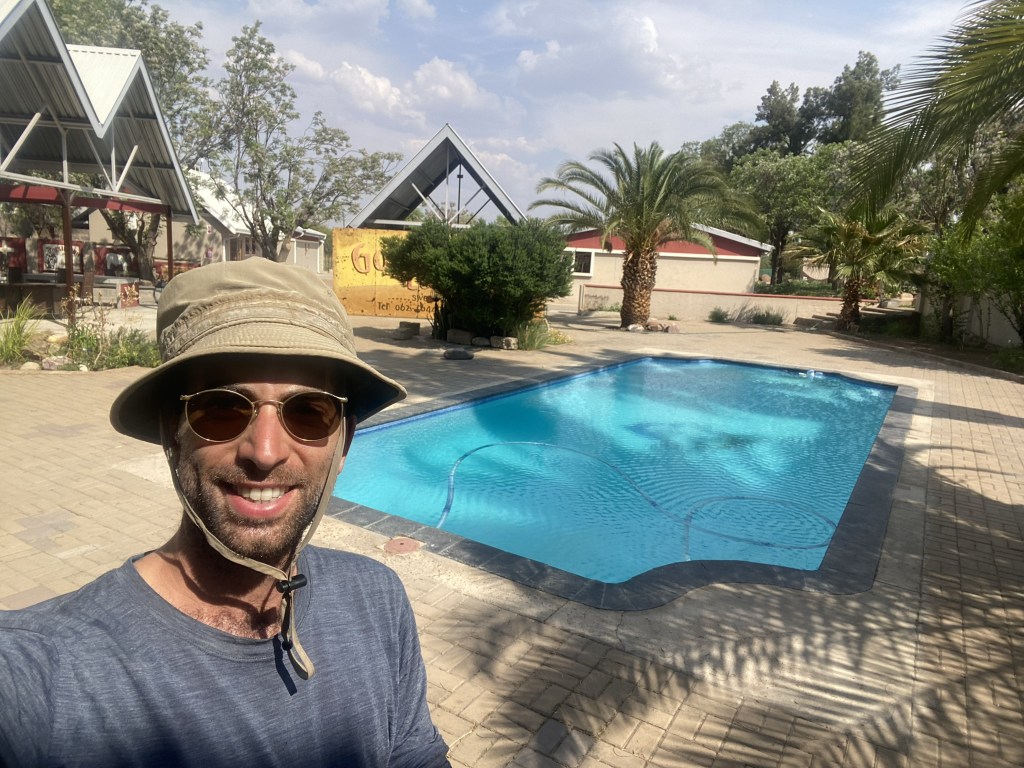 Cyclist arriving in gobabis hotel by the swimming pool