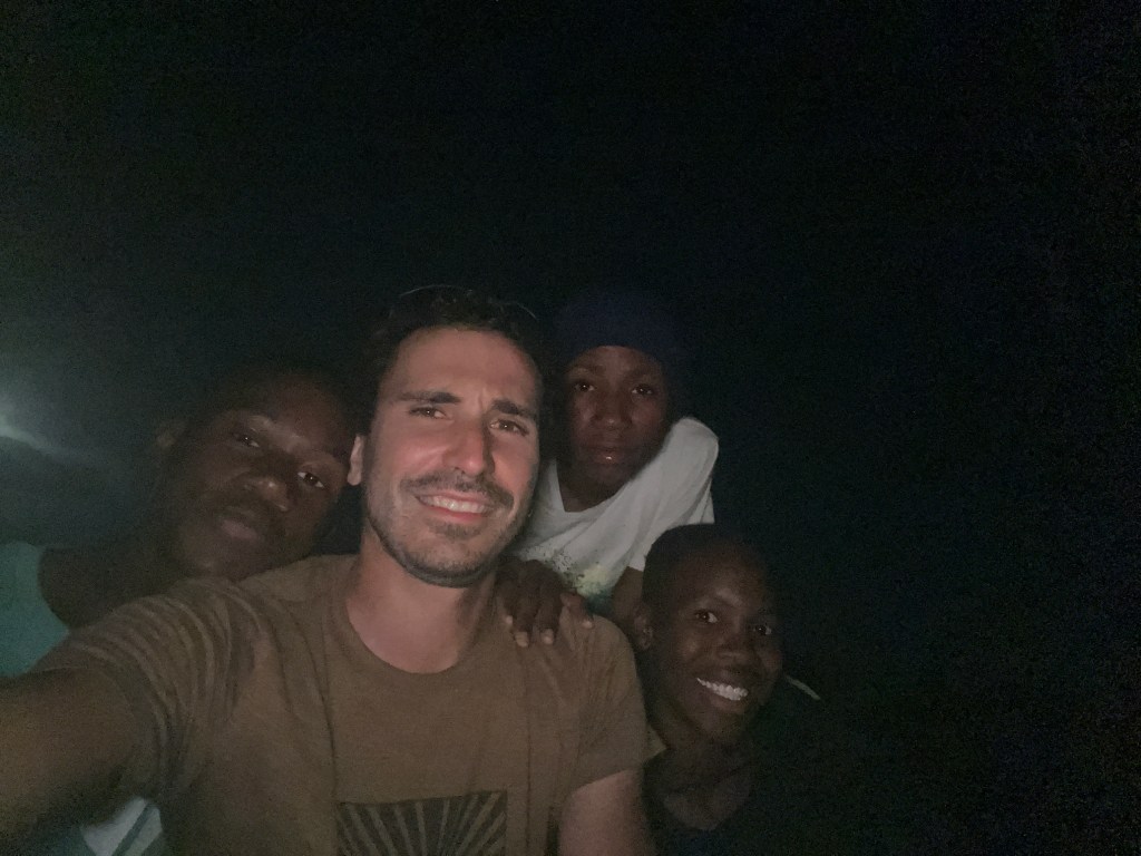 A cyclist taking a selfie with three locals in Botswana 