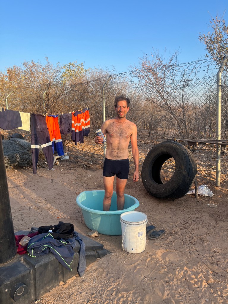 A cyclist showering in a bucket in a communication antenna 