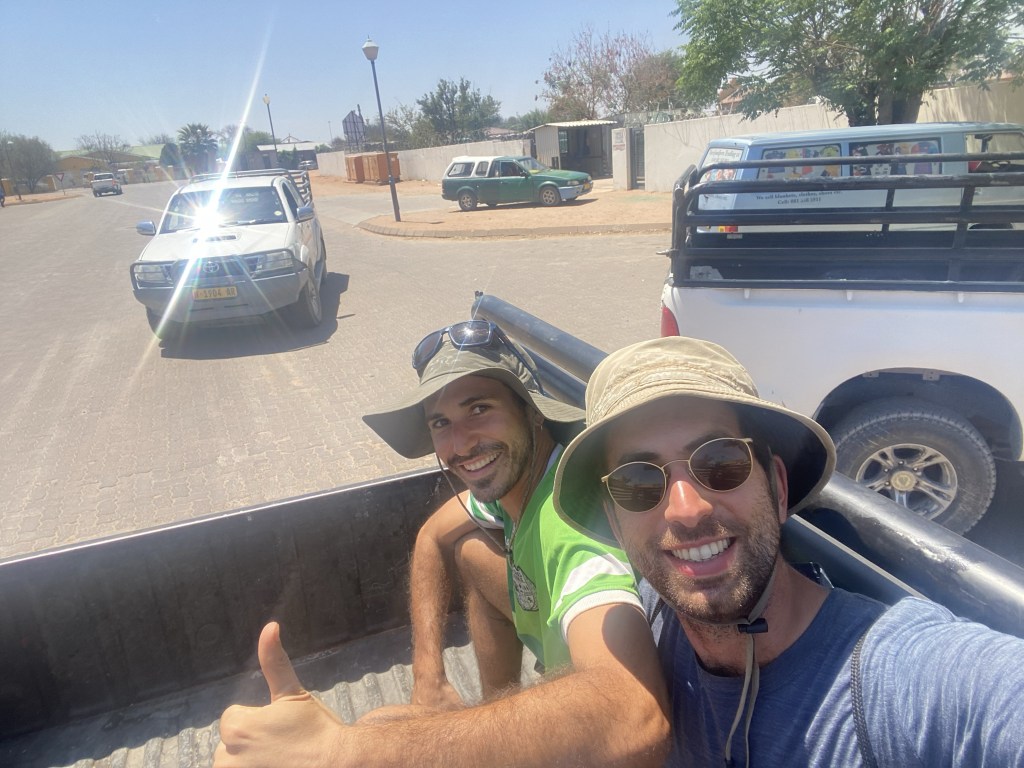 Two cyclist in the truck of a pick up car in gobabis 