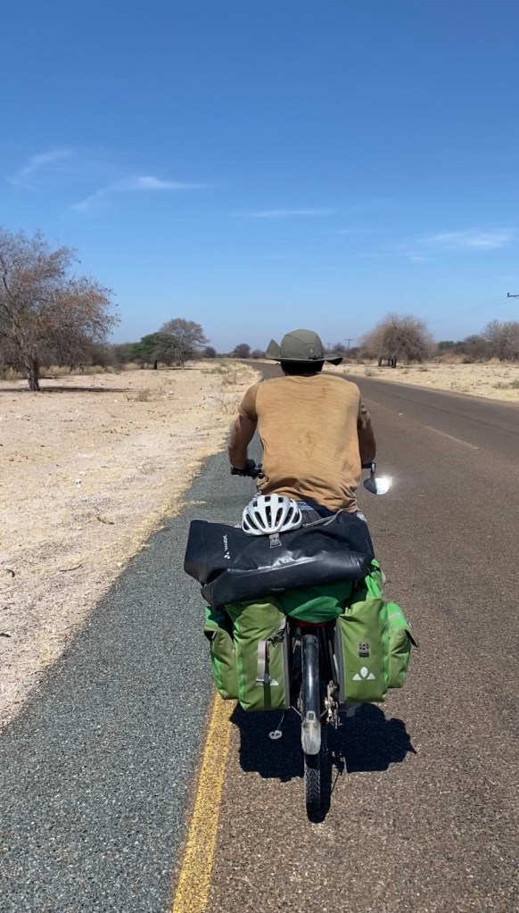 Cyclist on the road from Maun to Sehithwa